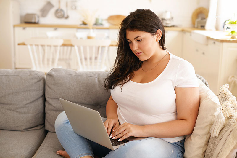 Woman on couch researching SIPS Surgery